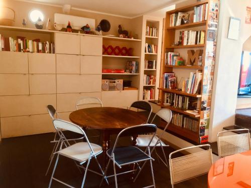 a table and chairs in a room with bookshelves at Martina Guest House in Genova