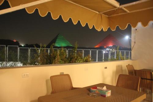 a dining room with a table and some pyramids at Farida Pyramids Boutique Hotel in Cairo