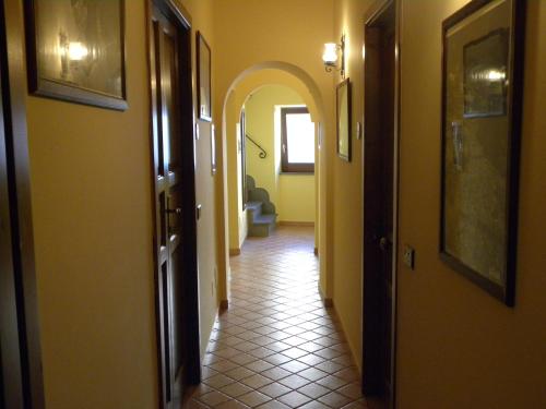 a hallway with an archway and a tile floor at Case Vacanze Albamarina in Lipari