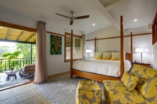 a bedroom with a bed and a balcony at San Ignacio Resort Hotel in San Ignacio