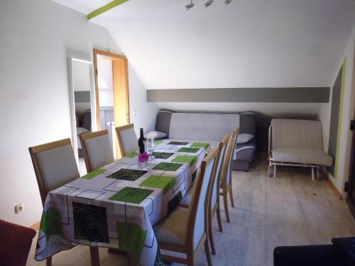 a dining room with a long table and chairs at Eifel Lodge in Butgenbach