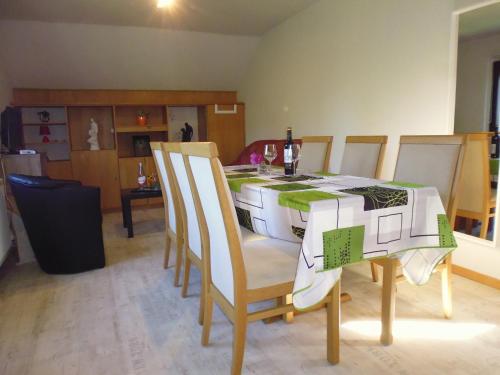 a dining room with a table with chairs at Eifel Lodge in Butgenbach