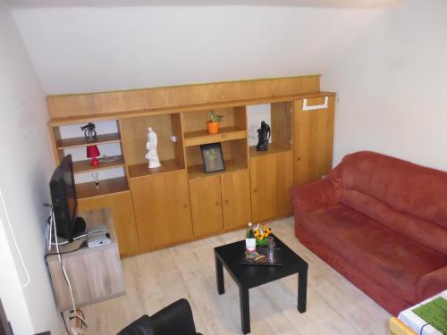 a living room with a couch and a table at Eifel Lodge in Butgenbach