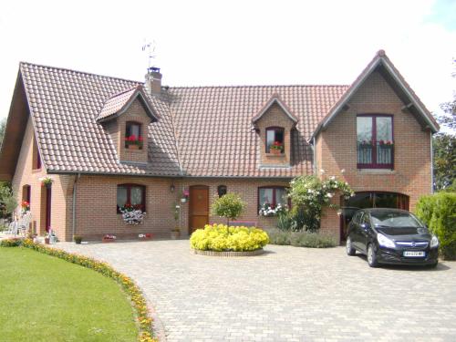a house with a car parked in front of it at Au fil de l'Eau in Saulzoir