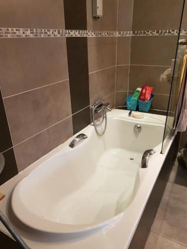 a white bath tub in a bathroom at VILLA BEAUSEJOUR in Cannes