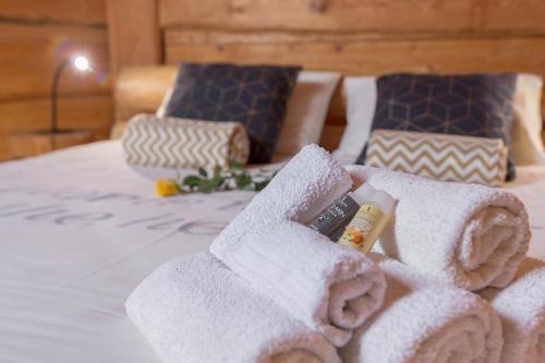 a pile of towels on top of a bed at Wellness hiska Izabela in Križevci pri Ljutomeru