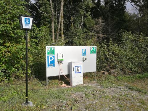 a gas pump next to a sign in a field at Hotel "Cafe Verkehrt" - Wellcome Motorbiker, Berufsleute und Reisende im Schwarzwald in Oberhof
