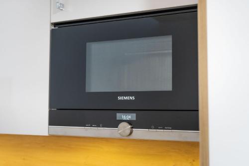 a flat screen tv sitting on top of a wooden floor at Seaside - Apartamenty KOMFORT, widok na morze, Parking in Kołobrzeg