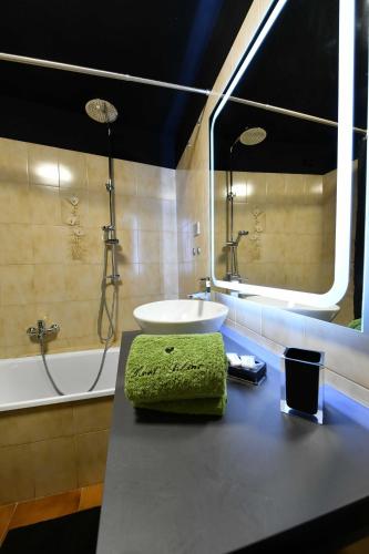a bathroom with a sink and a tub and a mirror at Maison I Love Mont Blanc in Courmayeur