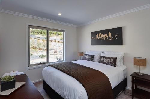 a bedroom with a large bed and a window at Esperance Landing in Dover