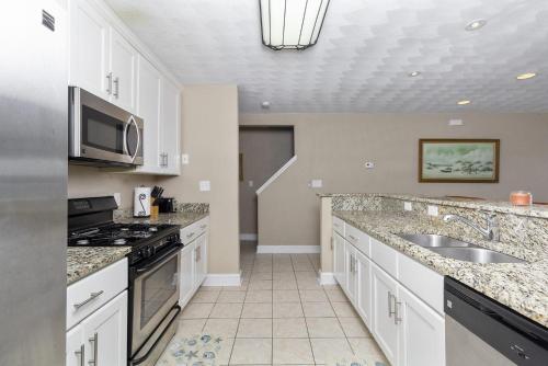 a kitchen with a sink and a microwave at Water Front Delight On The Bay Home in Norfolk