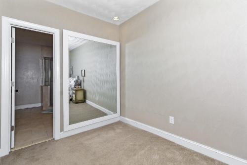 an empty room with a mirror and a hallway at Water Front Delight On The Bay Home in Norfolk