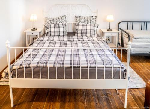 a white bed in a bedroom with two night stands at Apartamenty przy STONEHENGE in Sosnowiec