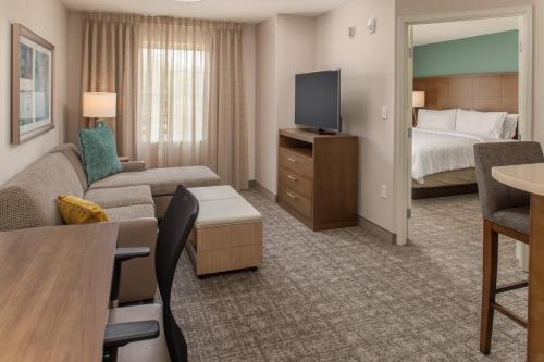 a hotel room with a couch and a bed at Staybridge Suites - Hillsboro North by IHG in Hillsboro