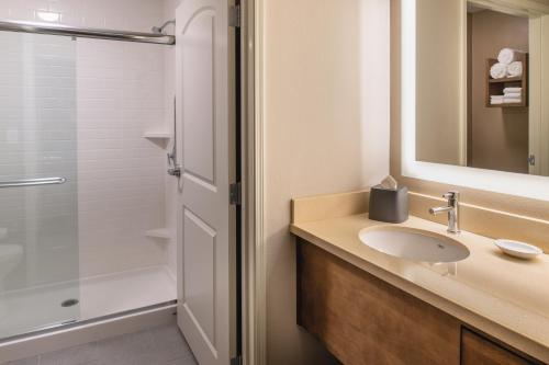 a bathroom with a sink and a shower at Staybridge Suites - Hillsboro North by IHG in Hillsboro