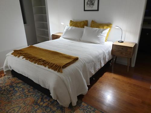 a bedroom with a bed with a blanket on it at Charolais Cottage in Picton