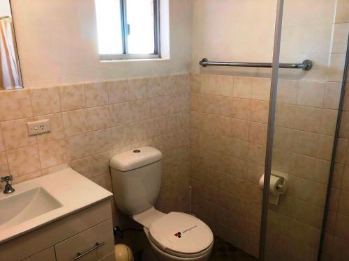 
a bathroom with a toilet a sink and a bath tub at Flat 2 - 3 Bay Lane in Kianga
