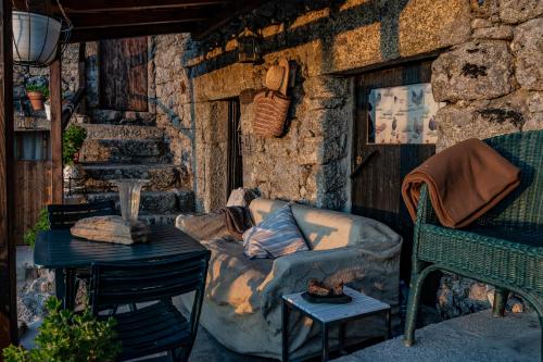 a living room with a couch and a table at Old House in Monsanto