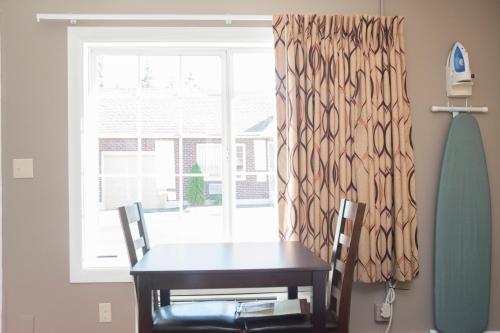 a table and two chairs in front of a window at Capitol Hill Motel in Portland