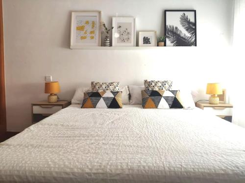 a bedroom with a large white bed with pillows at Finca Paredes in Valdetorres de Jarama