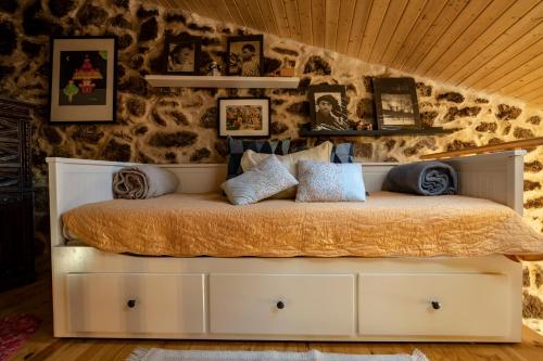 a bed with pillows on it in a room at Old House in Monsanto