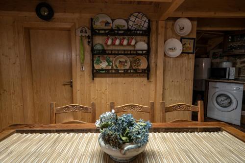a kitchen with a table with a vase of flowers on it at Old House in Monsanto