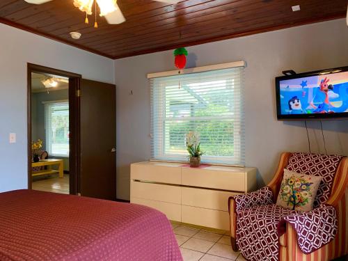 a bedroom with a bed and a flat screen tv at Lakeside Inn and Cafe in Saint Cloud