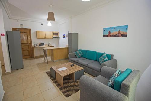 a living room with two couches and a coffee table at Lilly City Center Hostel in Hurghada