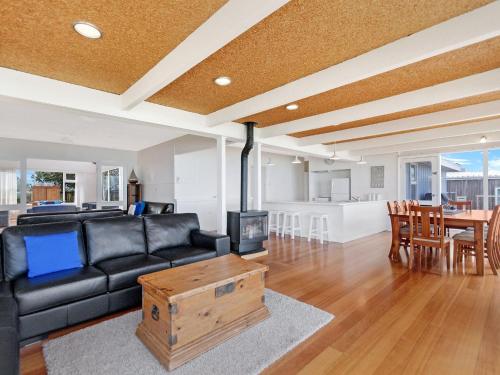 a living room with a black couch and a table at ONE FISH, TWO FISH in Port Fairy