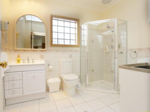 a bathroom with a shower and a toilet and a sink at Paradise Cove in Port Fairy