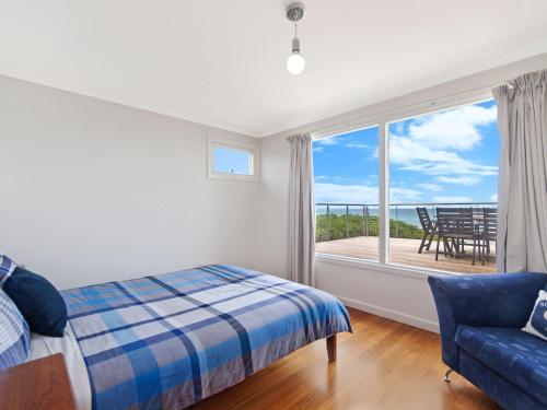 a bedroom with a bed and a view of the ocean at ONE FISH, TWO FISH in Port Fairy