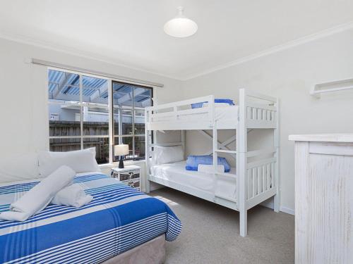a bedroom with two bunk beds and a desk at Rossanna in Port Fairy