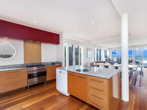 a kitchen with wooden cabinets and a counter top at RUBY'S BEACHFRONT in Port Fairy