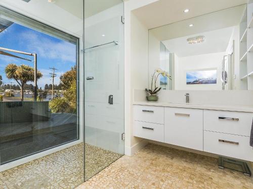 a bathroom with a glass shower and a sink at Rossleague House in Port Fairy