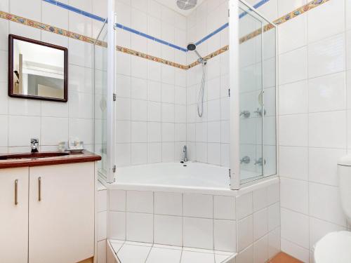 a bathroom with a tub and a shower at Shearwater Penthouse in Port Fairy