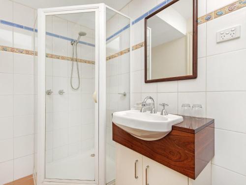 a bathroom with a sink and a shower at Shearwater Riverview Apartment in Port Fairy