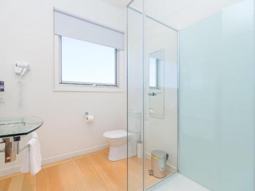 a bathroom with a toilet and a glass shower at Wytonia 2 in Port Fairy