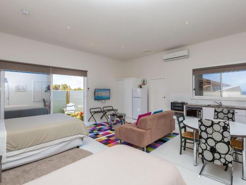 a bedroom with a bed and a living room at Wytonia Cabana in Port Fairy