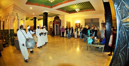 a group of people standing in a building at Palm's Hotel Club in Erfoud