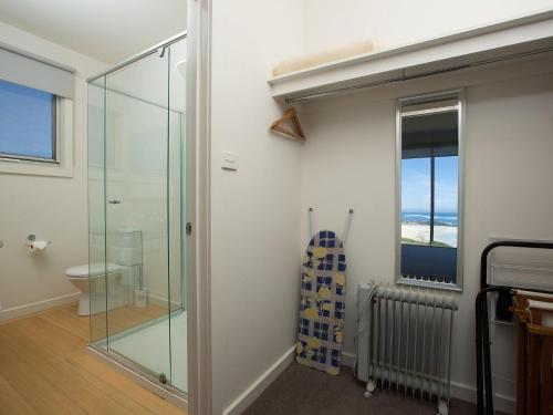 a bathroom with a glass shower and a toilet at Wytonia 3 Penthouse in Port Fairy
