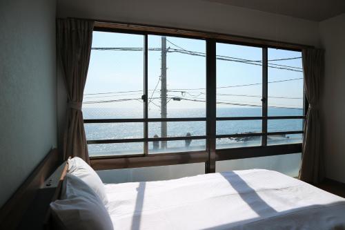 Postel nebo postele na pokoji v ubytování HOTEL&RESORT Izu no Ne
