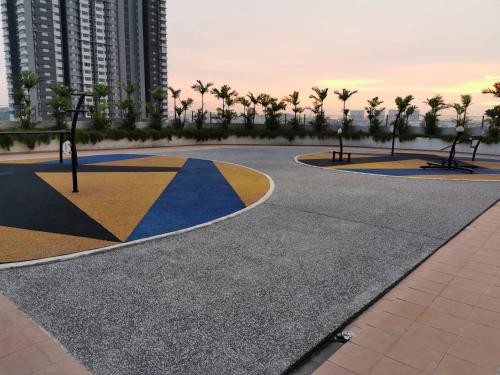 a walkway with palm trees and a building at Harmony Studio @ Evo SOHO Bangi in Kampong Sungai Ramal Dalam