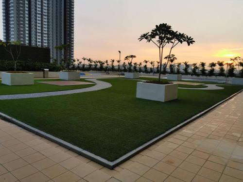 a park in a city with a palm tree in it at Harmony Studio @ Evo SOHO Bangi in Kampong Sungai Ramal Dalam