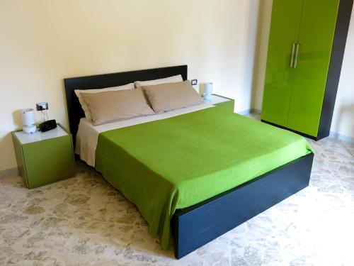 a bedroom with a large bed and green cabinets at B&B La Stazione in Acquaviva delle Fonti
