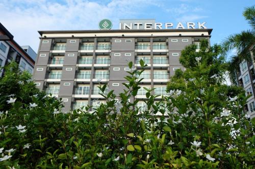 an apartment building with a sign on top of it at Interpark Hotel & Residence, Eastern Seaboard Rayong in Ban Phan Sadet Nok
