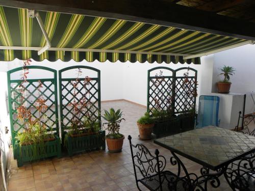 a patio with a table and some potted plants at Case Vacanze Albamarina in Lipari