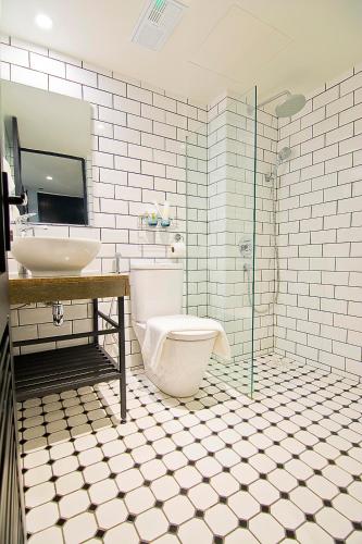 a bathroom with a toilet and a sink at JonkeRED Heritage Hotel in Melaka
