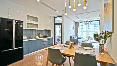 a kitchen and dining room with a table and chairs at Hi-Home Suites - Vinhomes Metropolis in Hanoi