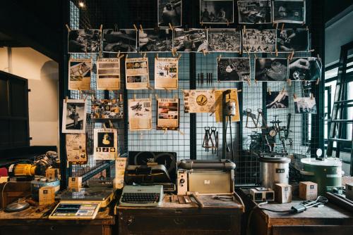 a room with a wall filled with lots of pictures at Kim Haus Loft in George Town