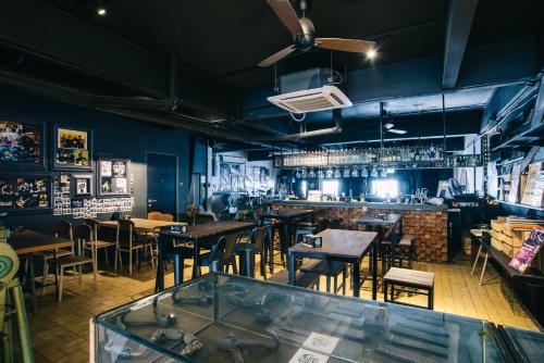 a restaurant with tables and chairs and a bar at Kim Haus Loft in George Town